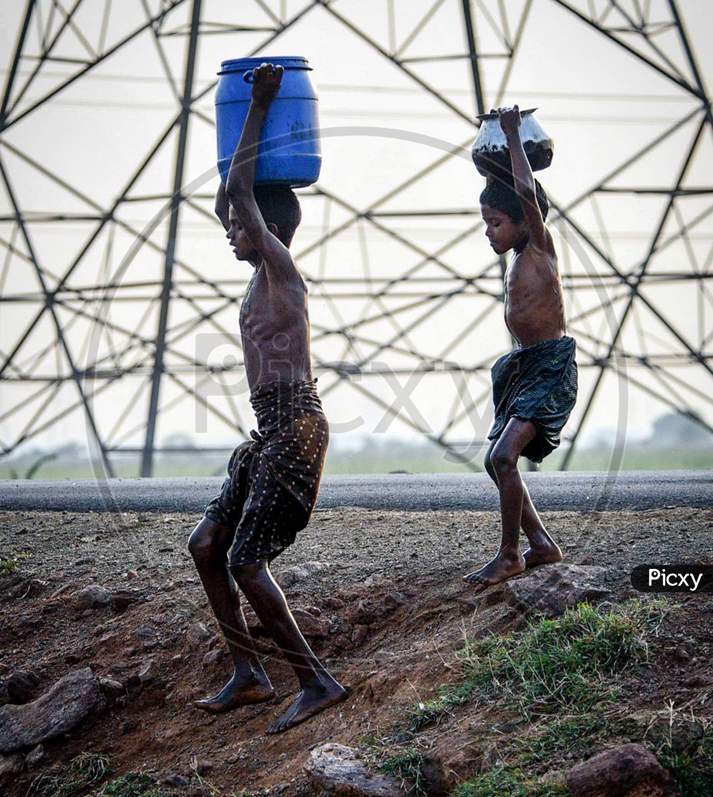 Young Indian Boys Carrying Water Vessels on Their Heads