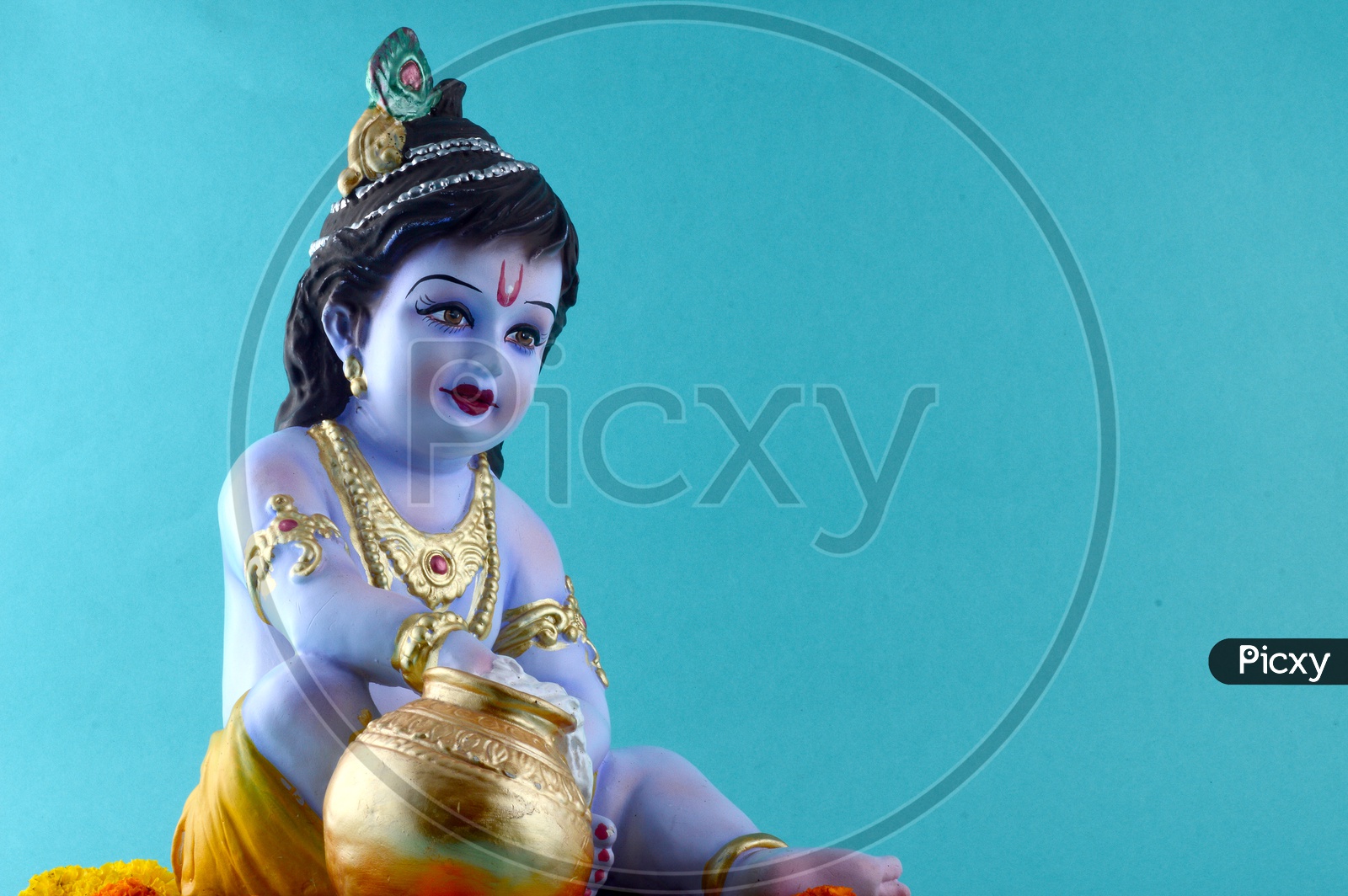 Little Krishna Idol on blue background
