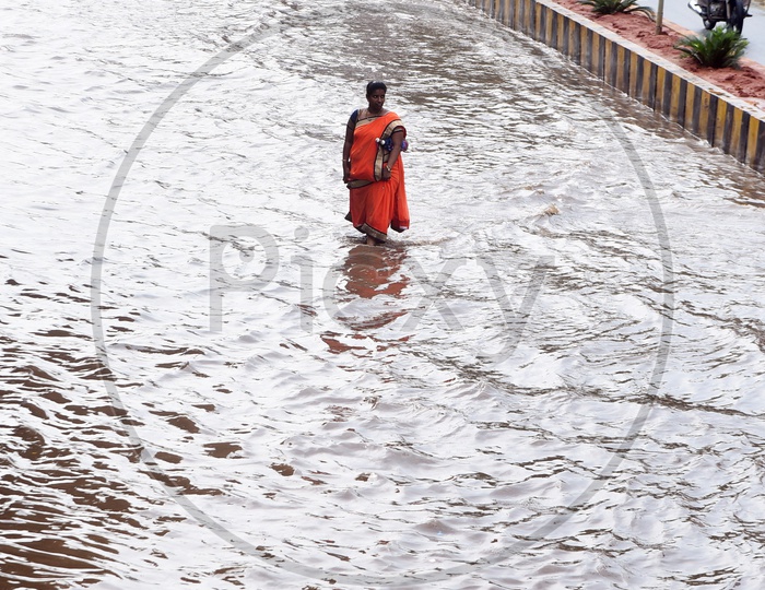A woman walking on the flooded road
