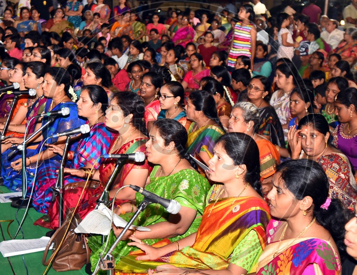 Indian women singing kirtans at a gathering