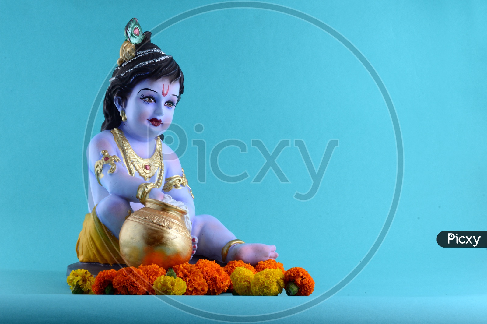 Little Krishna Idol on light blue background