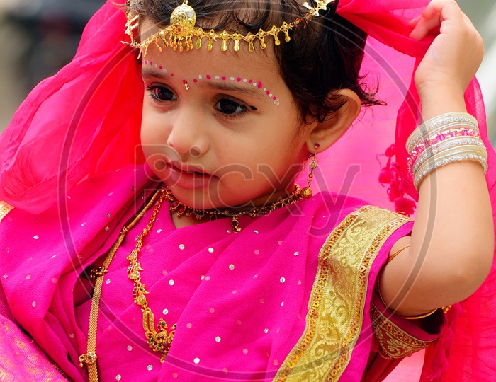 A Girl child dressed up in a saree