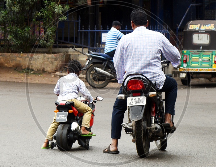 Father teaching his child riding a bicycle