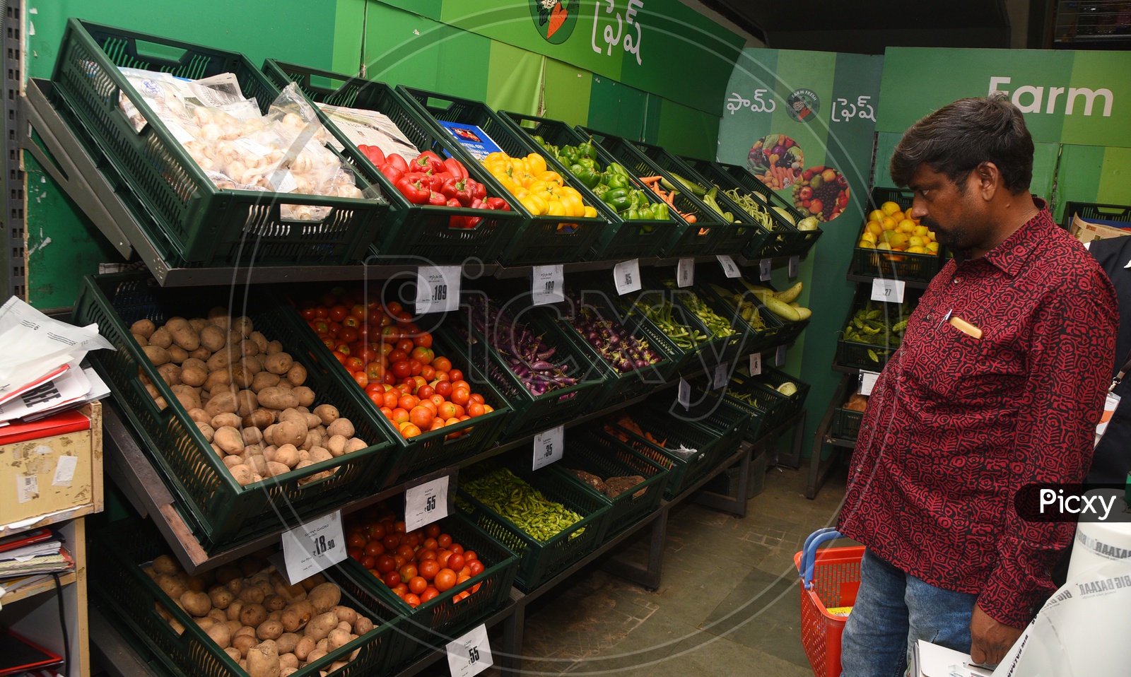 Consumer buying vegetables in a supermarket