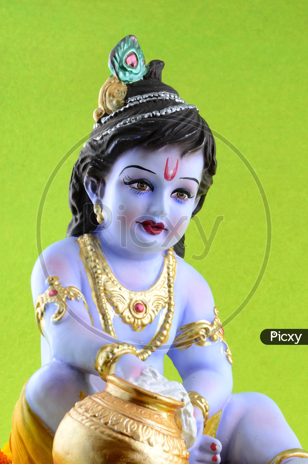 Little Krishna Idol on green background