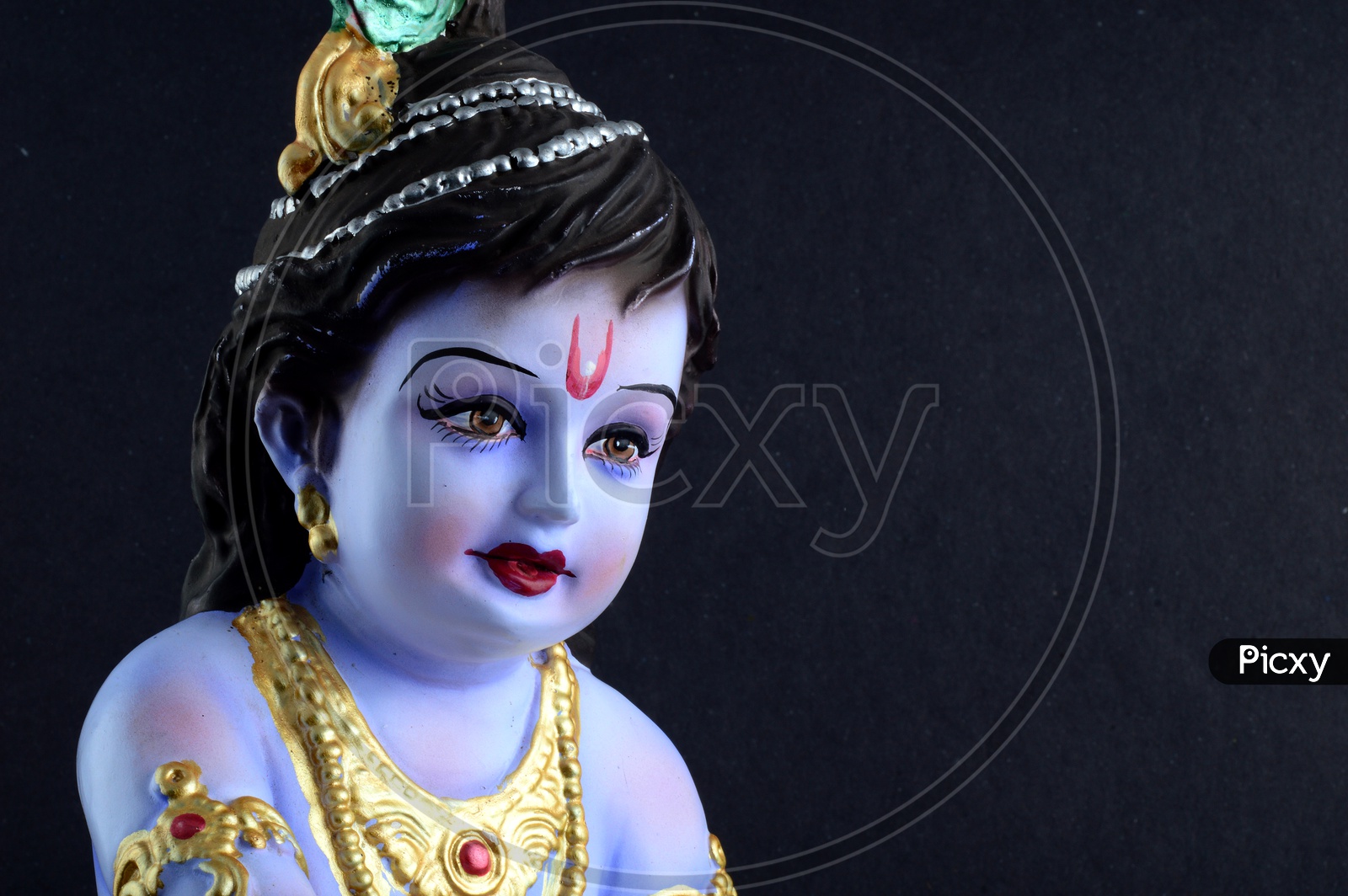Little Krishna Idol on black background