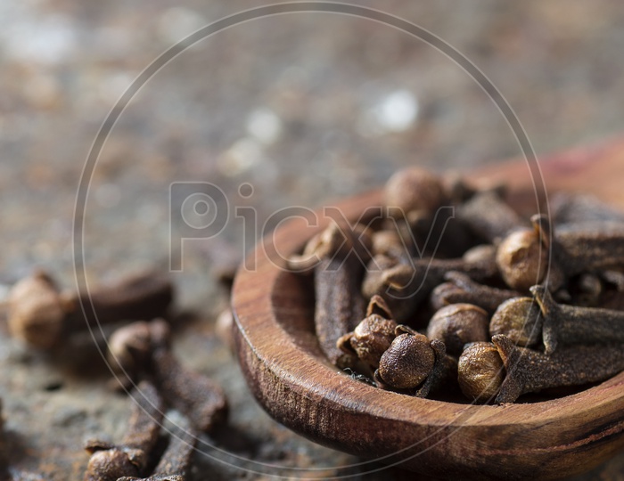 Close up shot of Clove in a wooden spoon