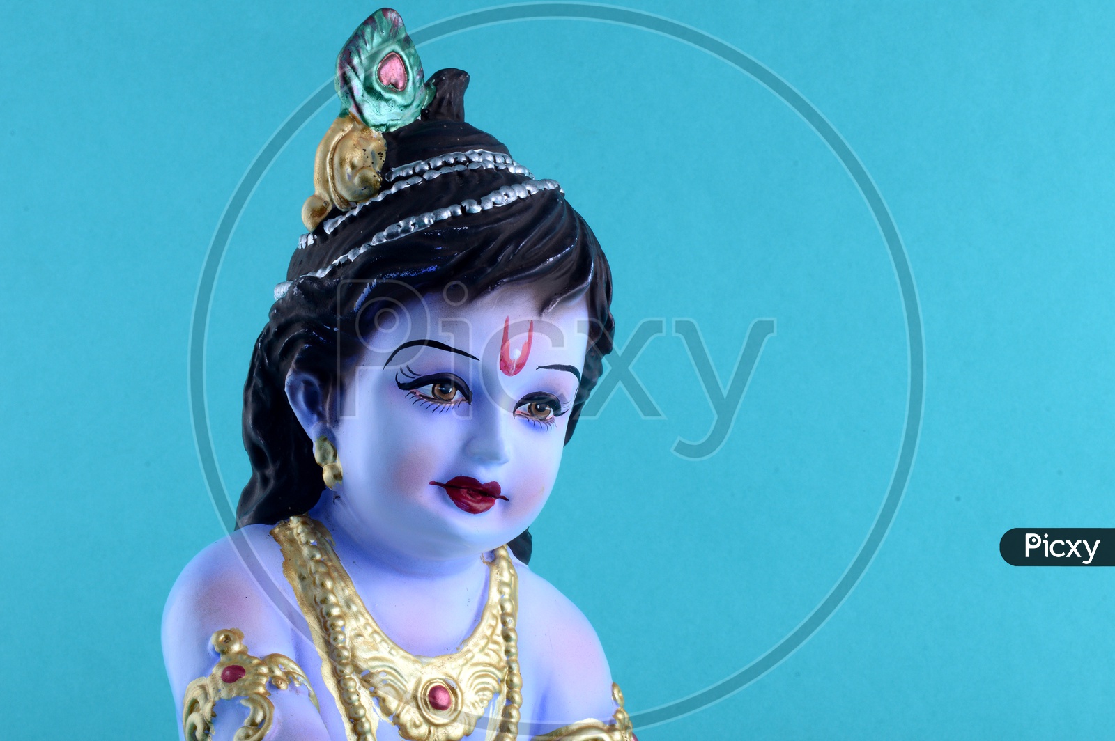 Image of Little Krishna Idol on blue background-NV426337-Picxy