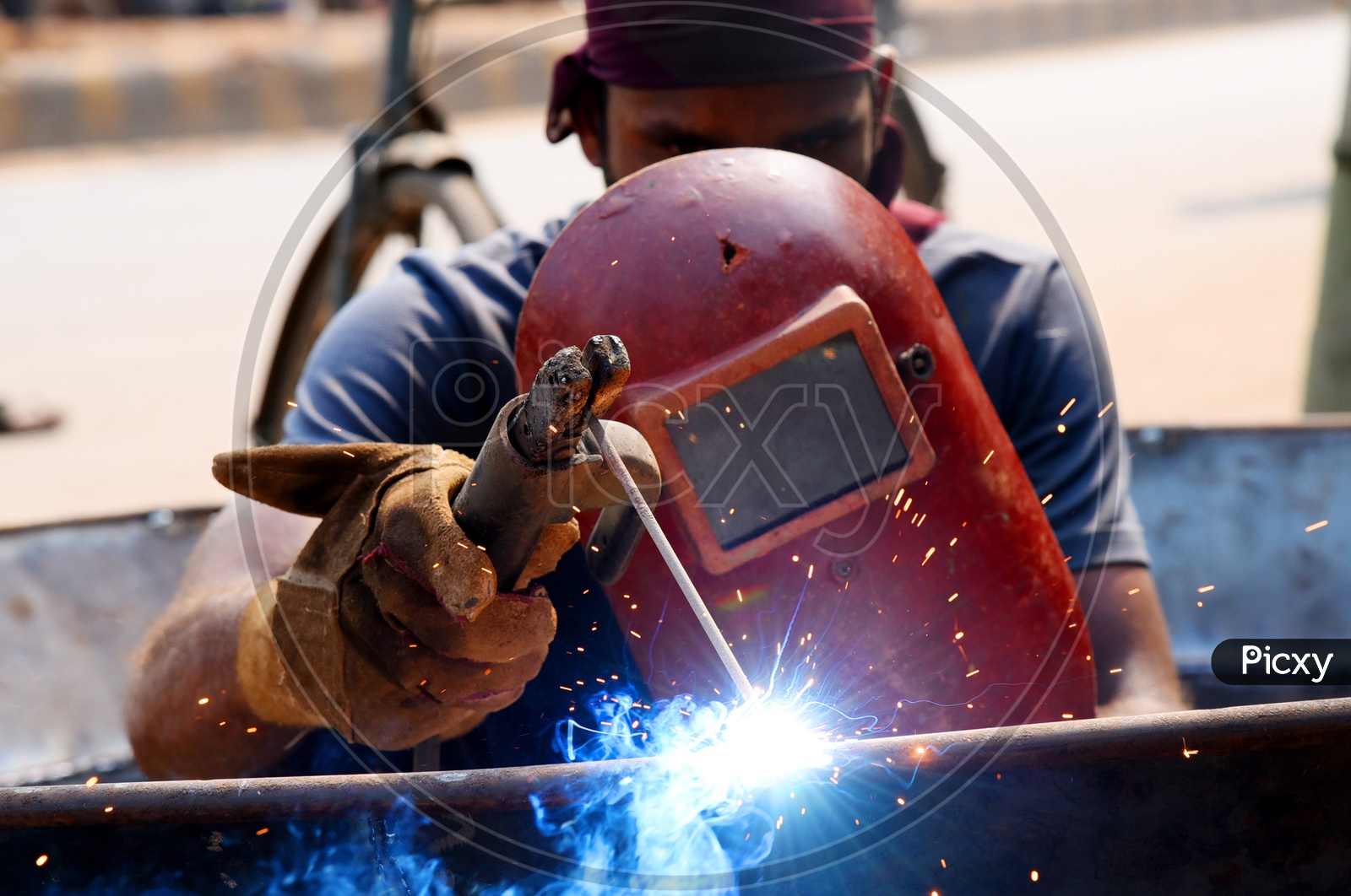 A worker welding work using protective shield