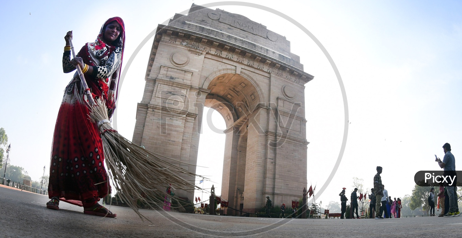 A woman sweeping the road at India Gate - Fish Eye View