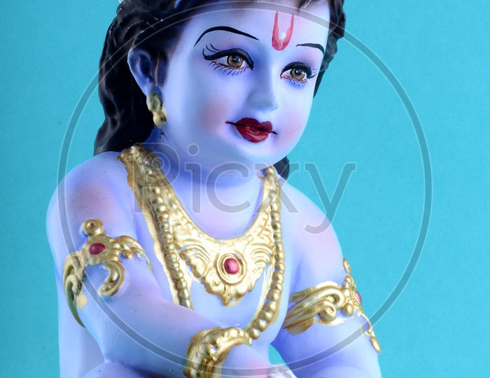 Little Krishna Idol on blue background