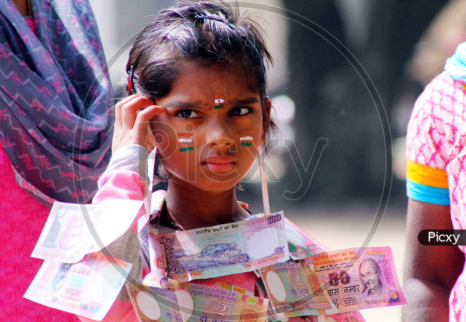 A girl child wearing money garland