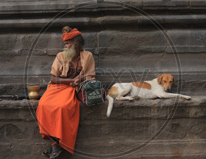 An Indian Sadhu Baba and a street dog