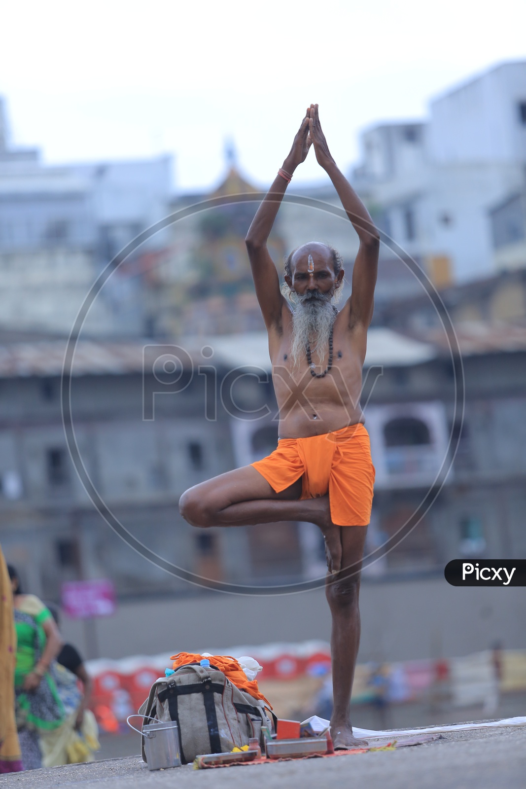 Indian Baba Or Sadhu Practicing Siddhi Yoga Asana on Ganga River Bank
