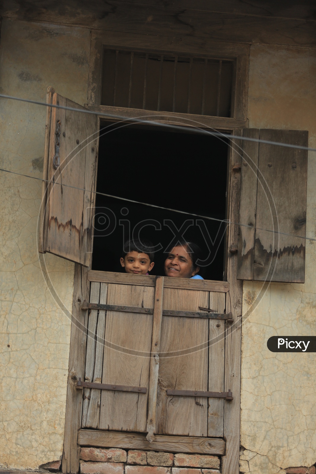 Child And Mother Looking Through The Window