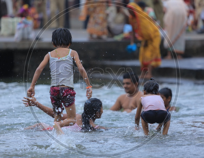 Children Taking Holy Bath In River Ganges During Kumbh mela