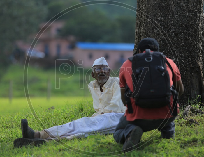 A photographer taking picture of an old muslim man