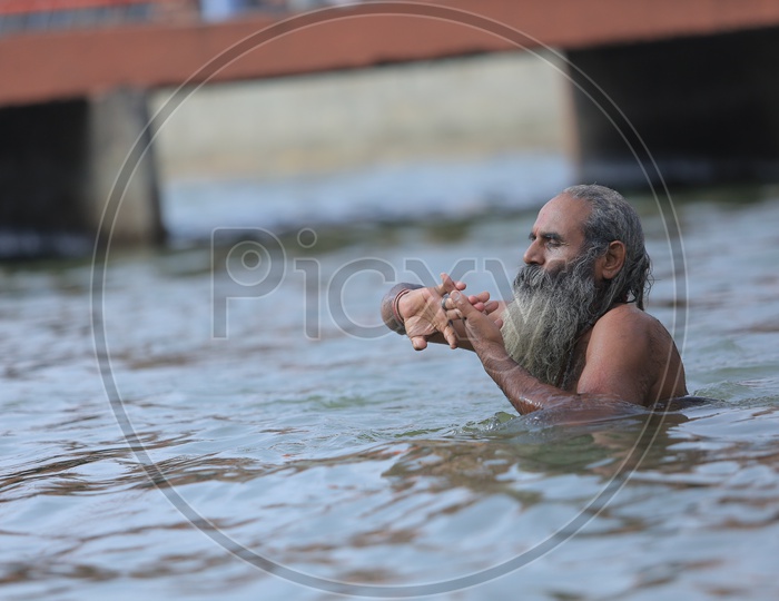 Hindu Sadhu or Baba Taking Holy Bath In River Ganges During Kumbh Mela
