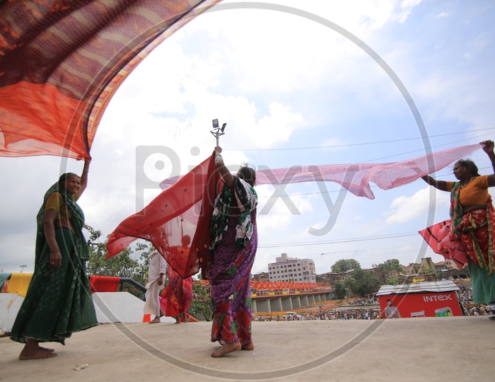Local Indian women holding sarees to dry