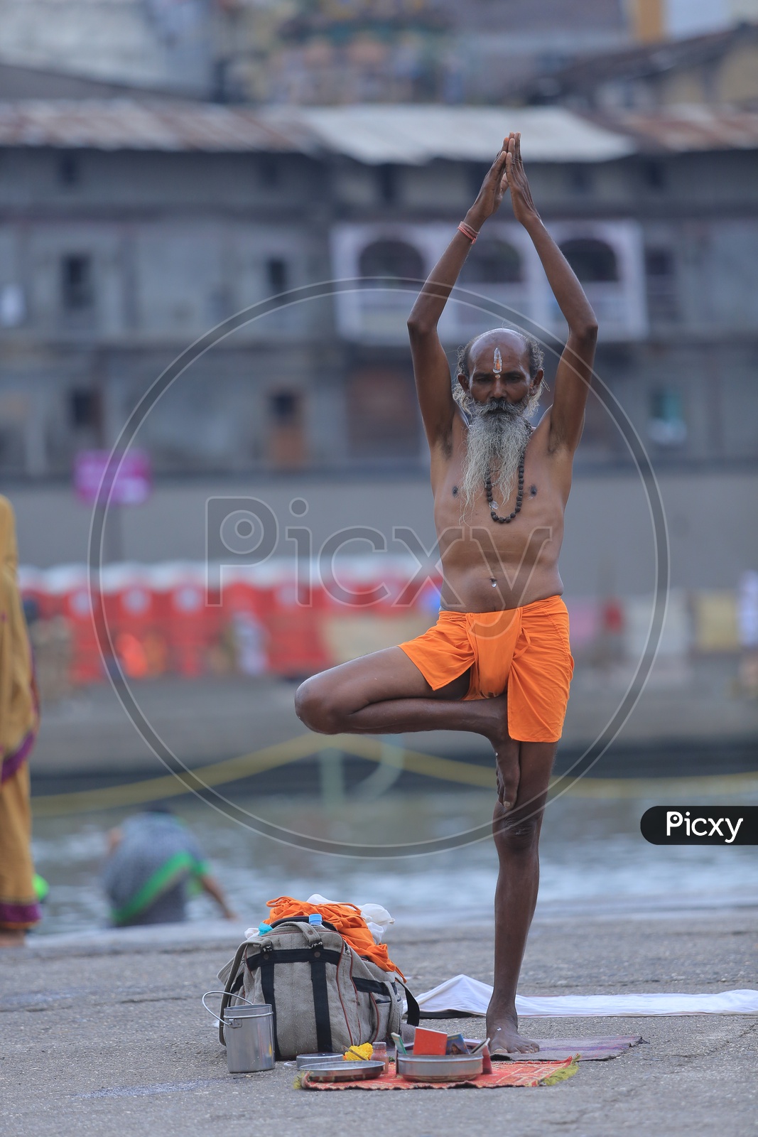 hindu Baba Or Sadhu Practicing  Siddhi Yoga Asanas on River Bank