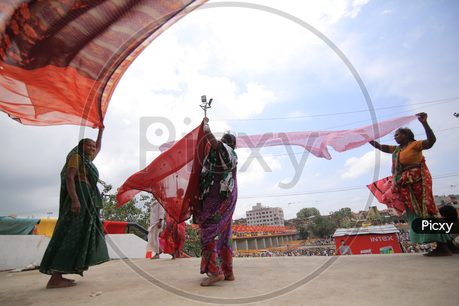 Local Indian women holding sarees to dry