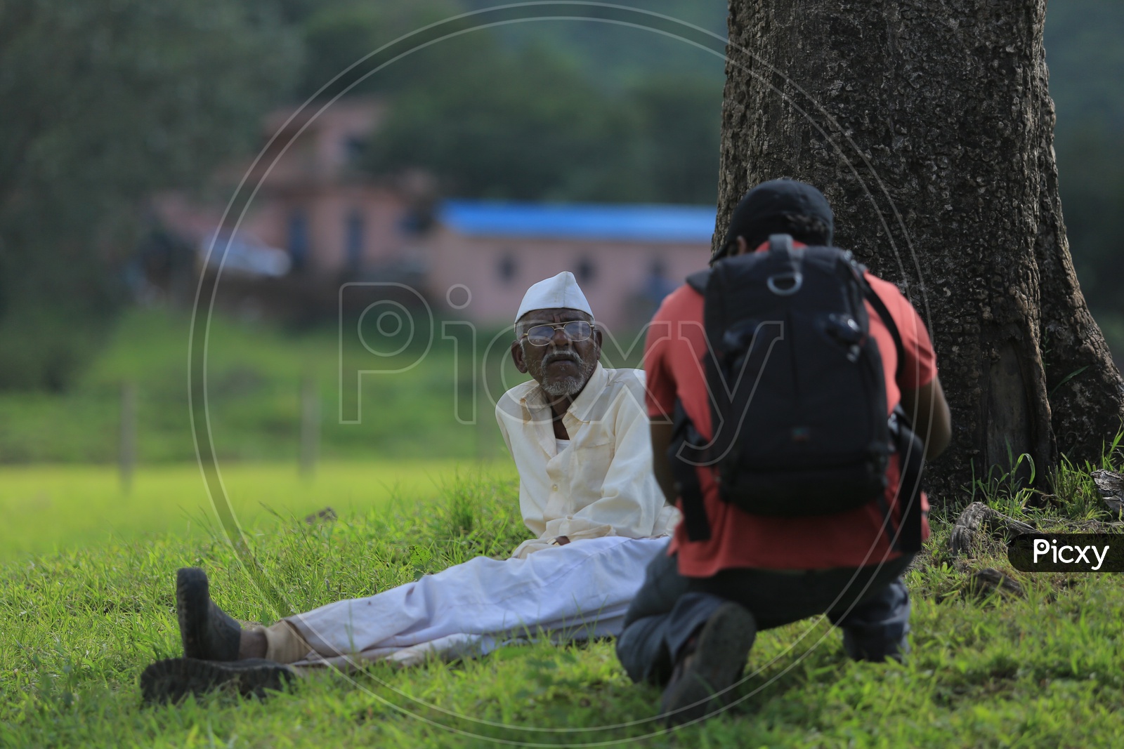 A photographer taking picture of an old muslim man