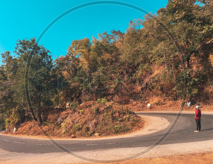 Lonely Man standing alongside the Ghat Road of a hill