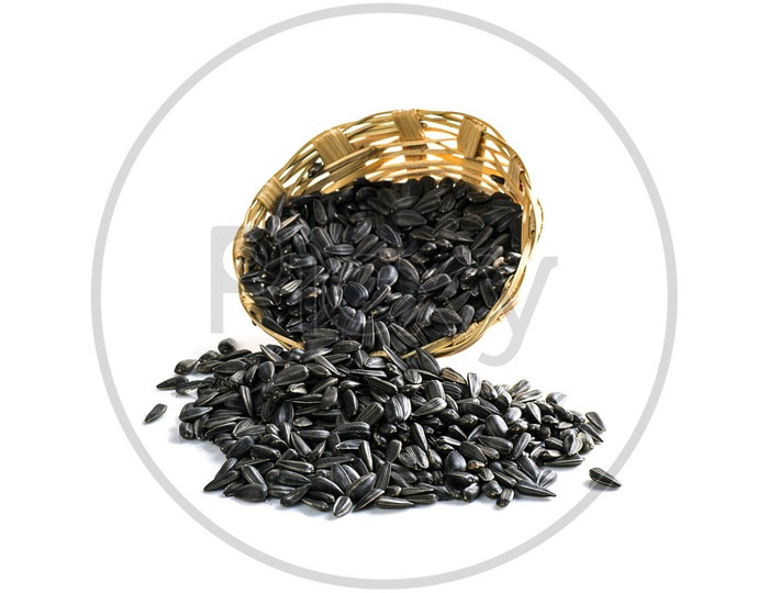 Black cardamom in a basket on a isolated white background