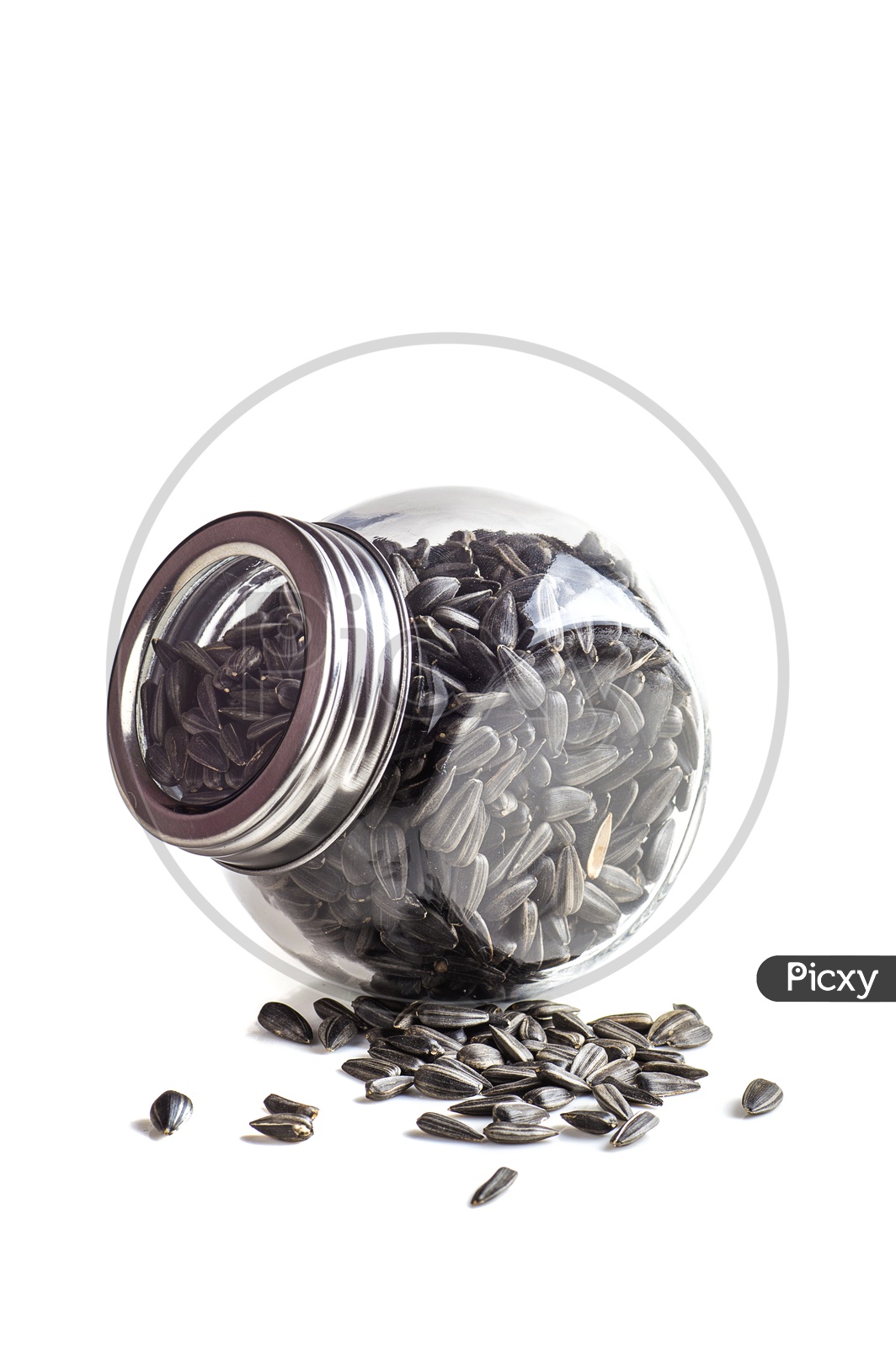 Sunflower seeds in glass jar on a isolated white background