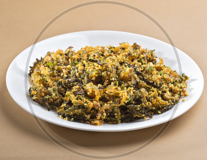 Bitter gourd fry with spices and herbs served in a plate