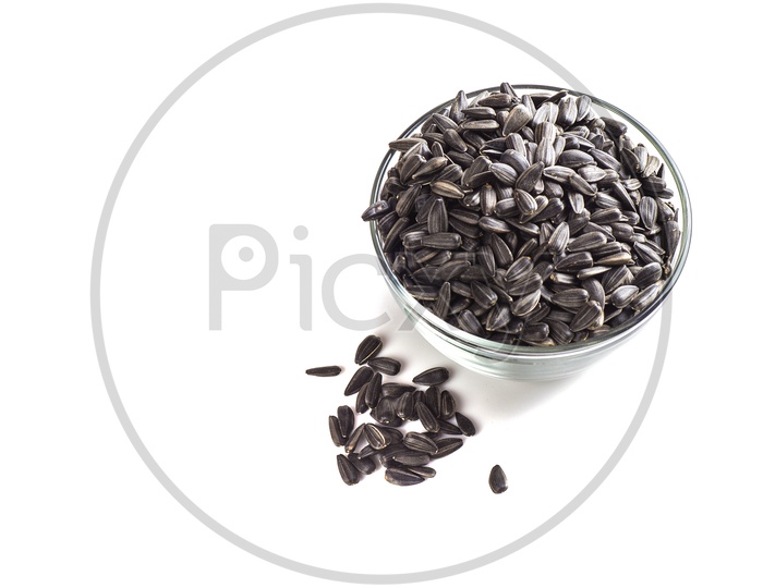Sunflower seeds in glass bowl on a isolated white background