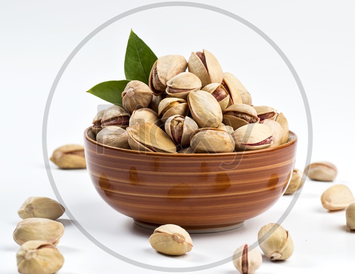 Pistachios in a Bowl on White Background