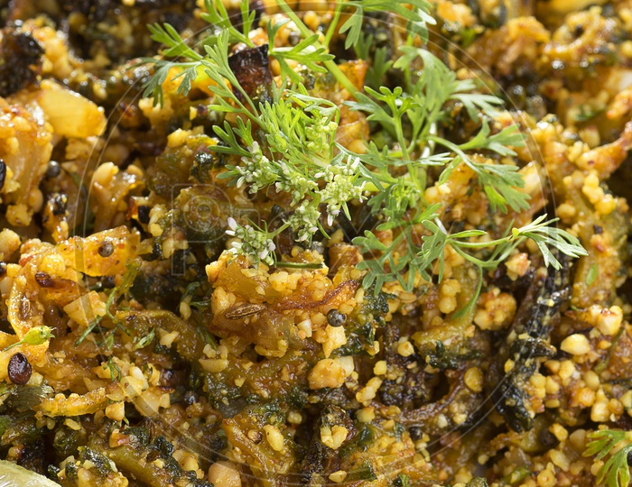 Close up shot of Bitter gourd fry with spices and herbs served in a plate