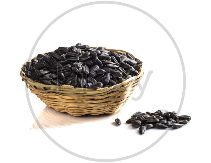 Black cardamom in a basket on a isolated white background