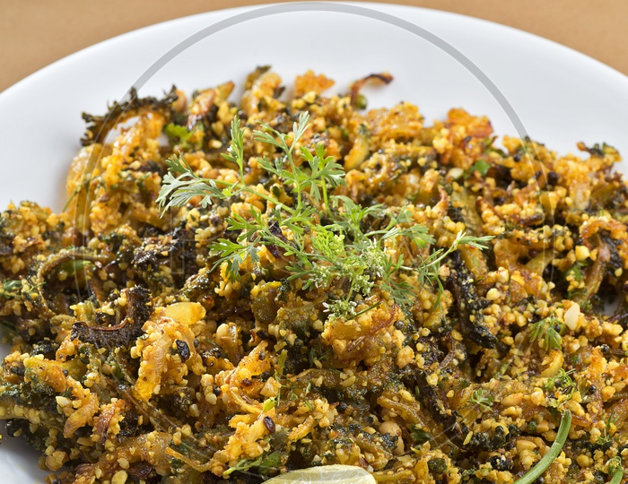 Bitter gourd fry with spices and herbs served in a plate