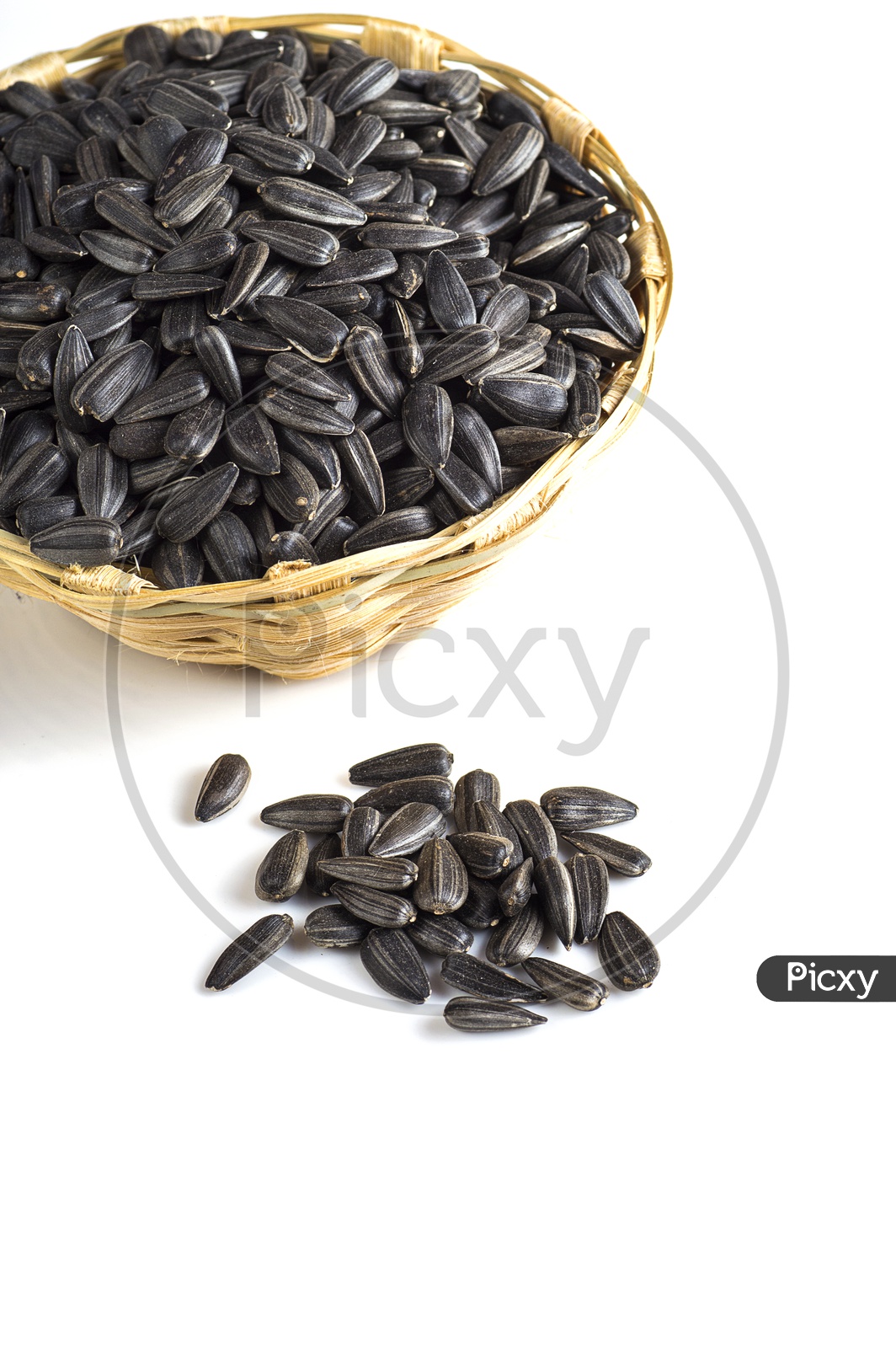 Sunflower seeds in a basket on a isolated white background