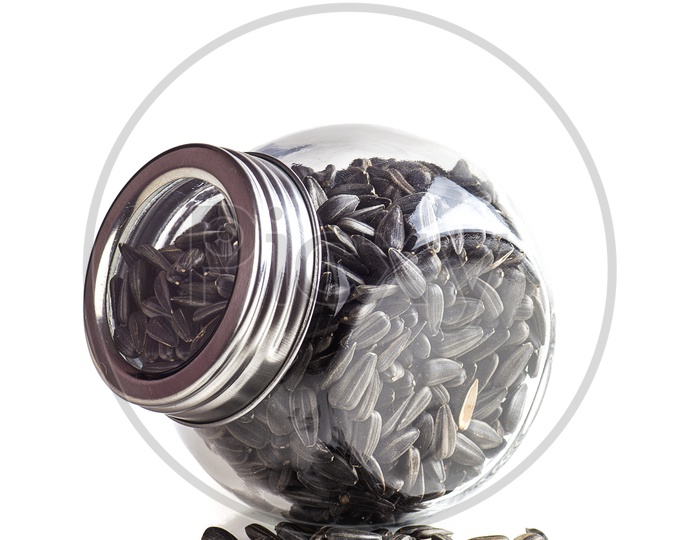 Sunflower seeds in glass jar on a isolated white background