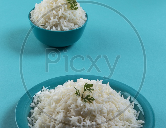 Image of Cooked plain white basmati rice in a blue plate and bowl on ...