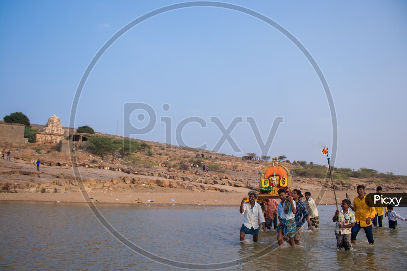 Devotees taking lord into water at Pushpagiri temple