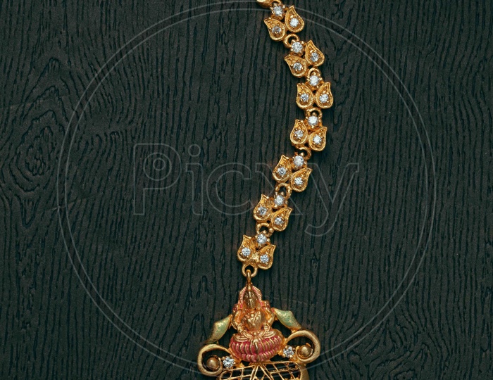 Traditional Maang Tikka with Lakshmi devi in the design and pearl
