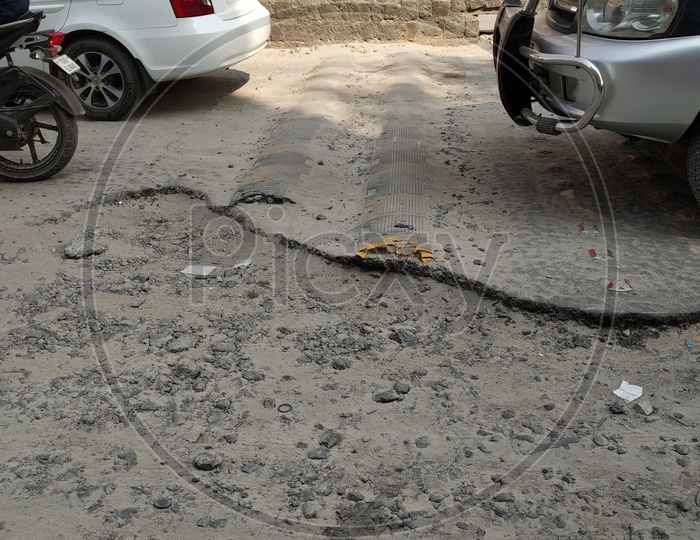 A damaged road. Potholes.