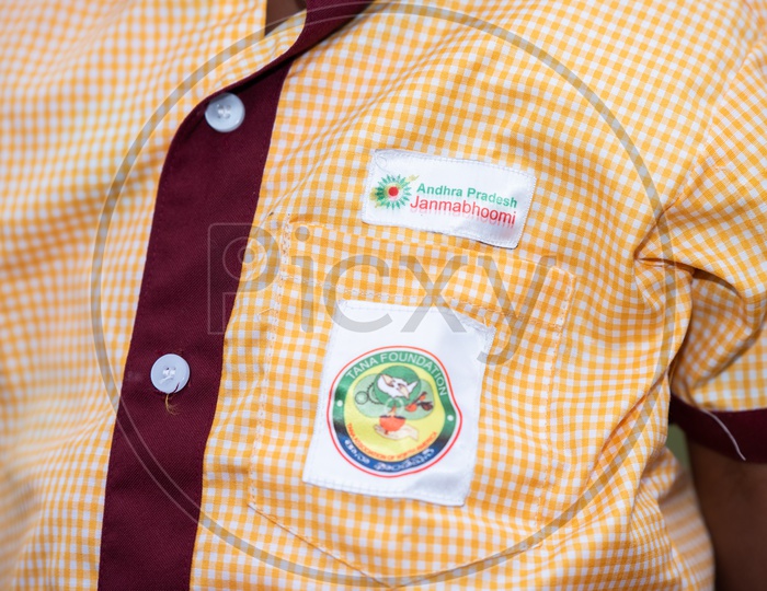 Logo of Andhra pradesh Janmabhoomi and TANA foundation on Anganwadi school uniform