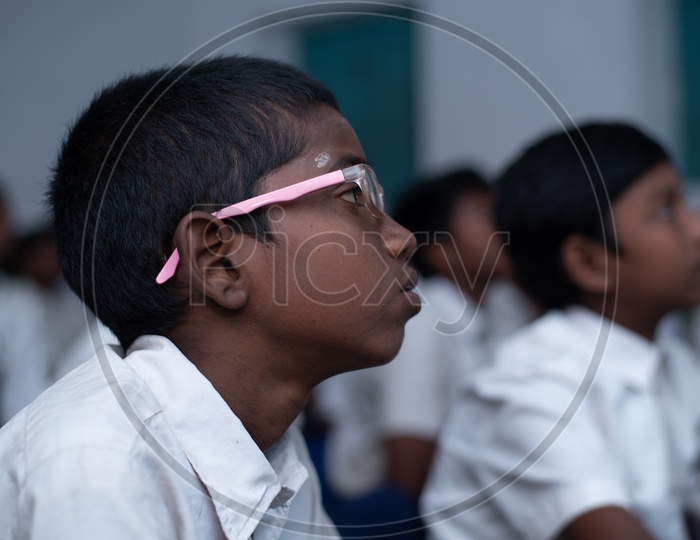 Student with specs in a classroom