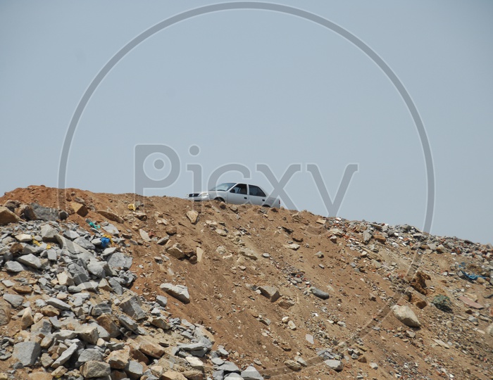 A stationary car on the top of a cliff