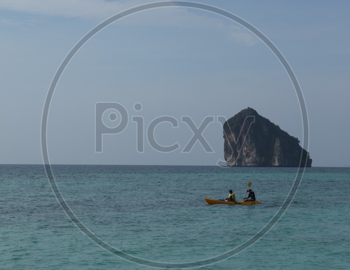 Boating in the sea with a mountain in the background