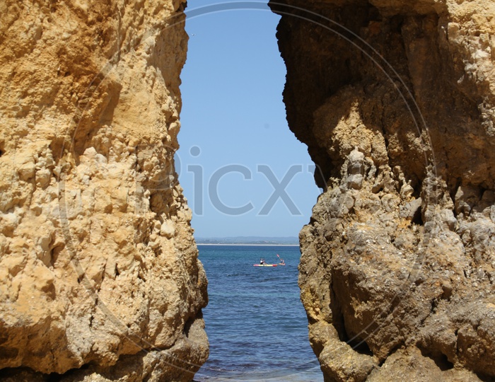 View of beach through large Rocks