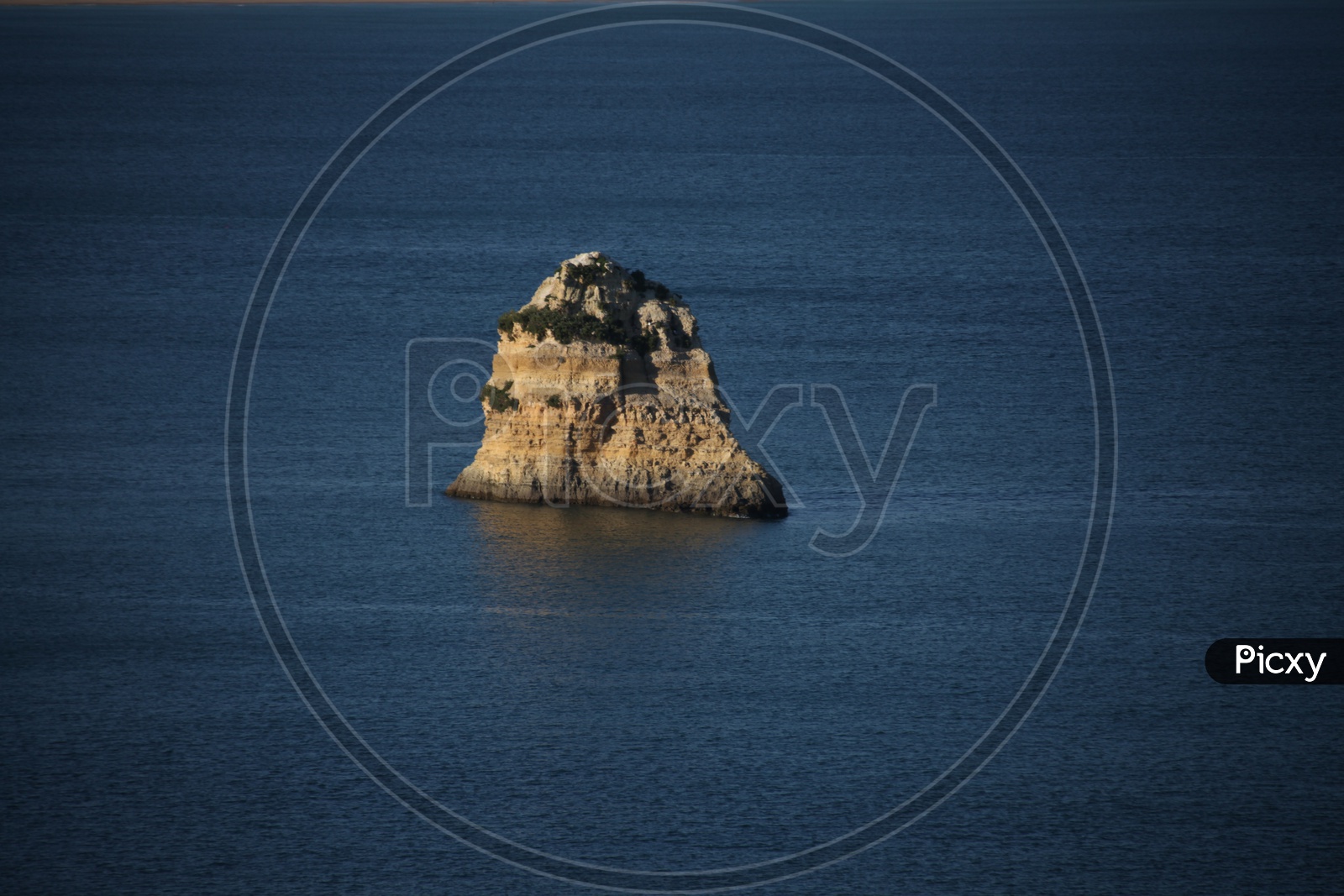 a large rock in the sea