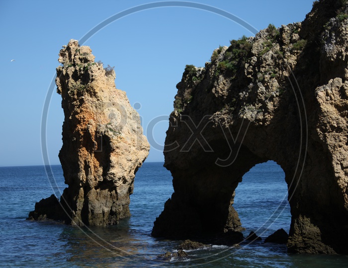 arch shaped rock and a cliff