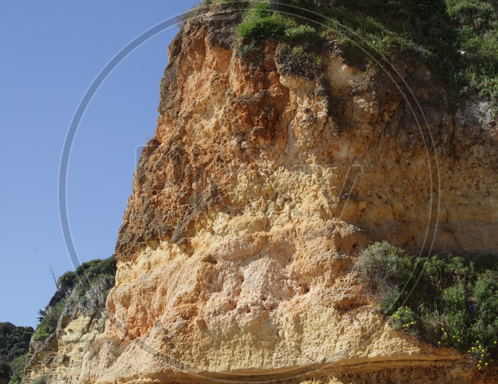 a person standing on the top of the cliff