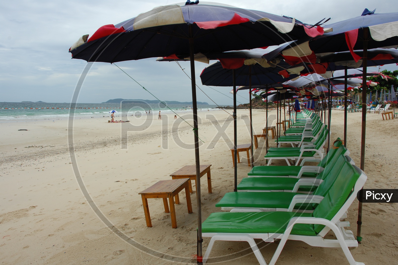 Pool chairs with umbrellas at the beach